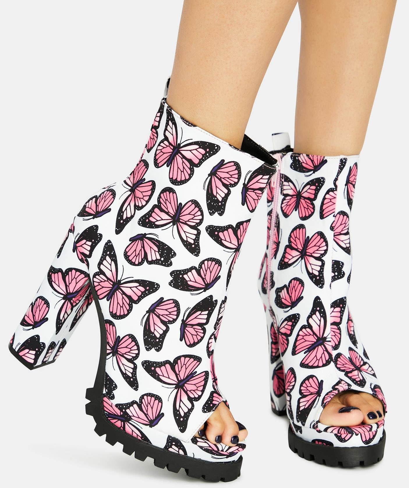 These chunky peep-toe booties are elevated with whimsical pink butterfly prints, adding a playful and feminine touch to any bold ensemble