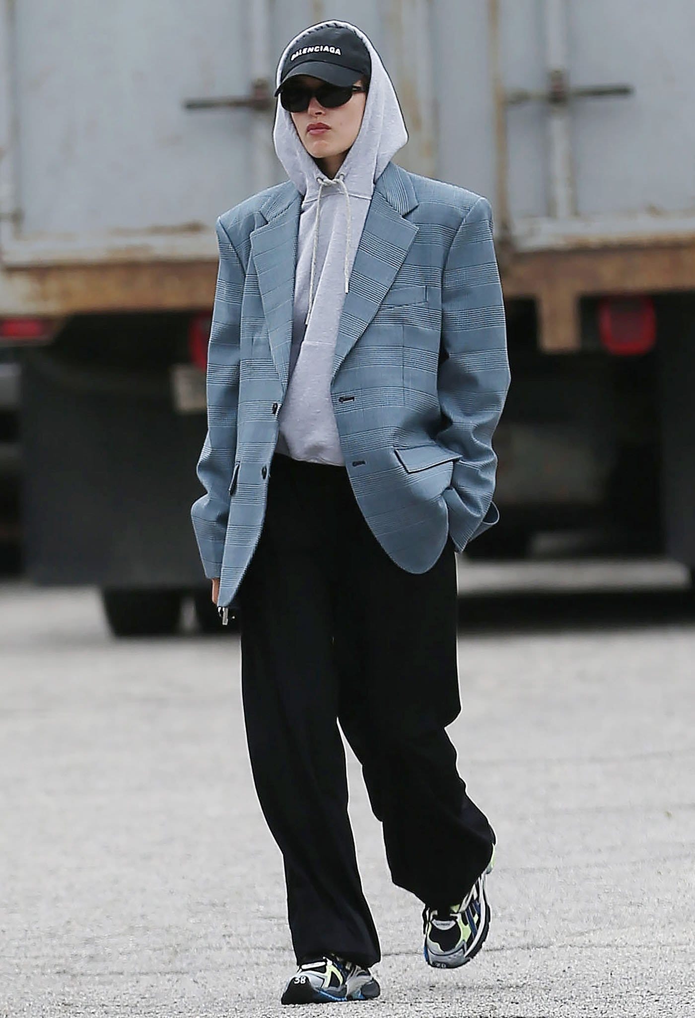Hailey Bieber channels androgynous street style in an oversized Vetements blazer and Wardrobe.NYC hoodie, finishing the look with Balenciaga Runner sneakers while running errands in Los Angeles on January 13, 2022