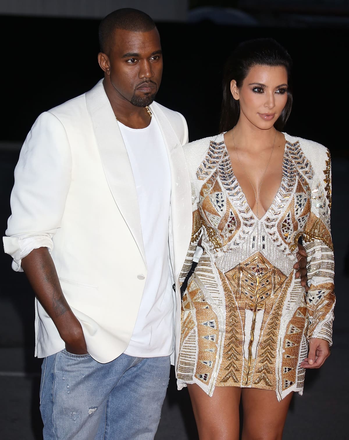 Standing 5 ft 2 in (157 cm), Kim Kardashian looks around six inches shorter than then-husband Kanye West as the pair step out in coordinating white and gold ensembles