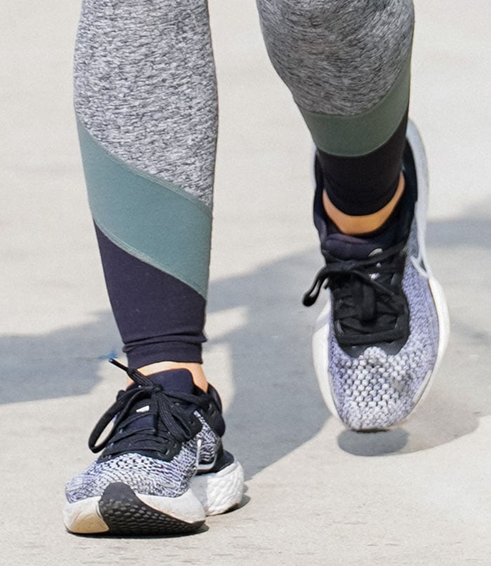 Lucy Hale finishes her sporty street-style look with Nike ZoomX Invincible Run Flyknit sneakers, spotlighting their cushioned sole and breathable knit design ideal for both workouts and everyday wear