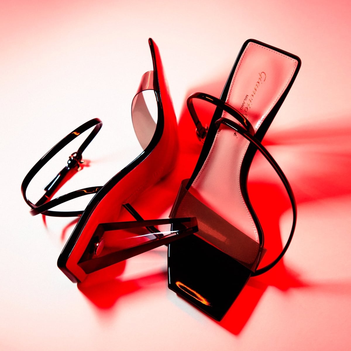 Gianvito Rossi's Odyssey sandals, shown here in sleek black, feature a unique architectural heel and a modern transparent toe strap, blending bold design with classic elegance