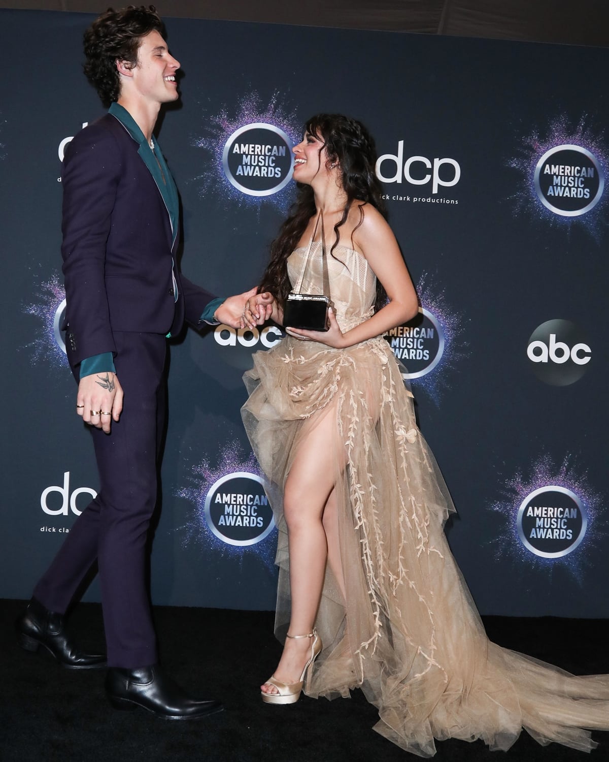Camila Cabello, noticeably shorter than then-boyfriend Shawn Mendes, dazzles in a sheer nude high-slit gown and platform heels at the American Music Awards before their 2021 split