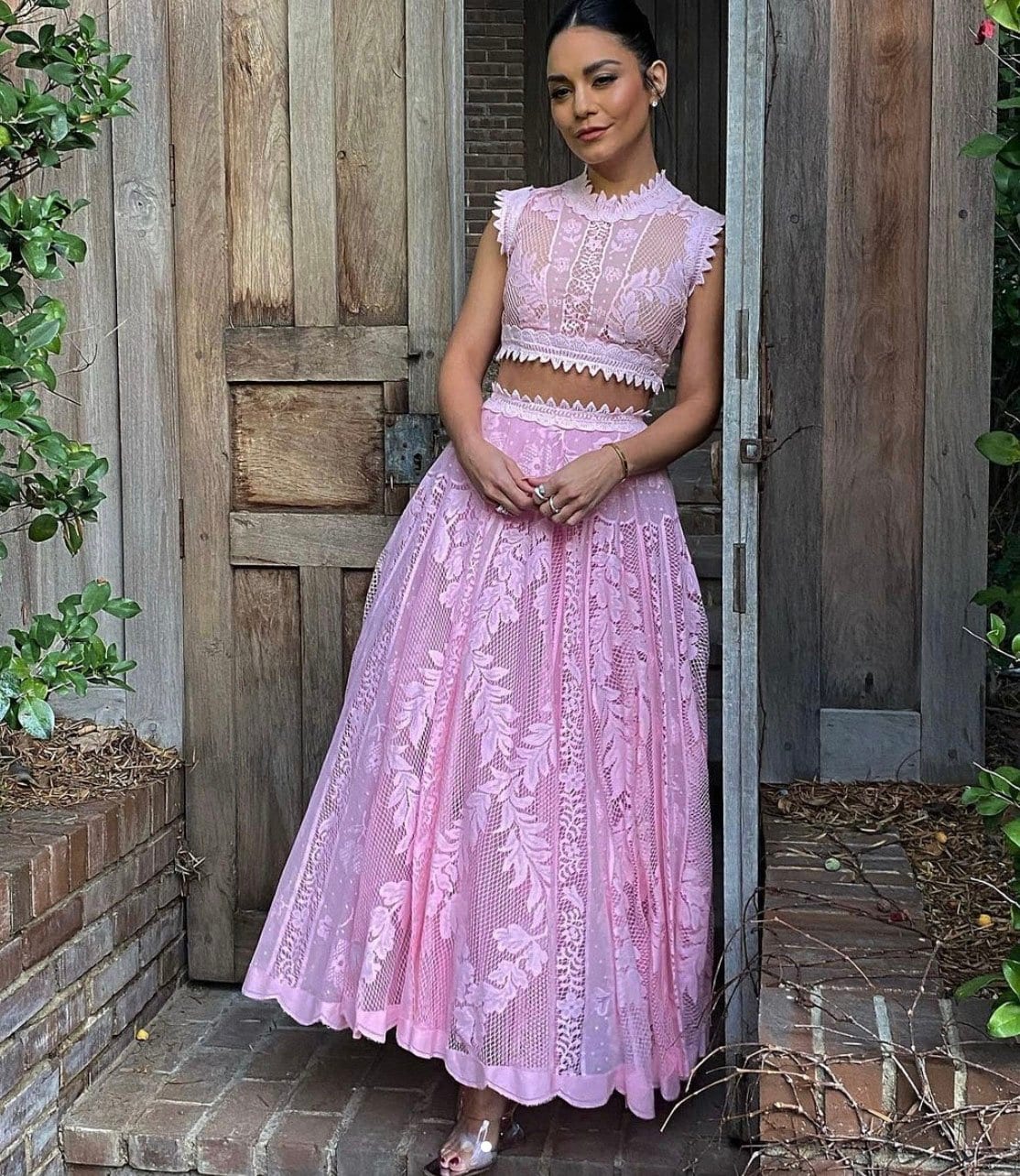 Vanessa Hudgens shows a glimpse of her midriff in a pink lace Giambattista Valli Spring 2022 dress