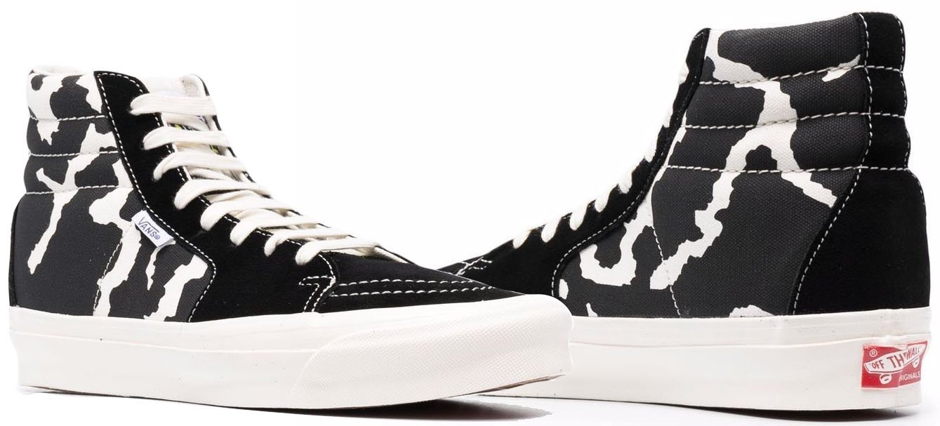 Add a bold twist to your casual look with Vans' cow-printed sneakers, featuring a striking black-and-white design perfect for laid-back outfits