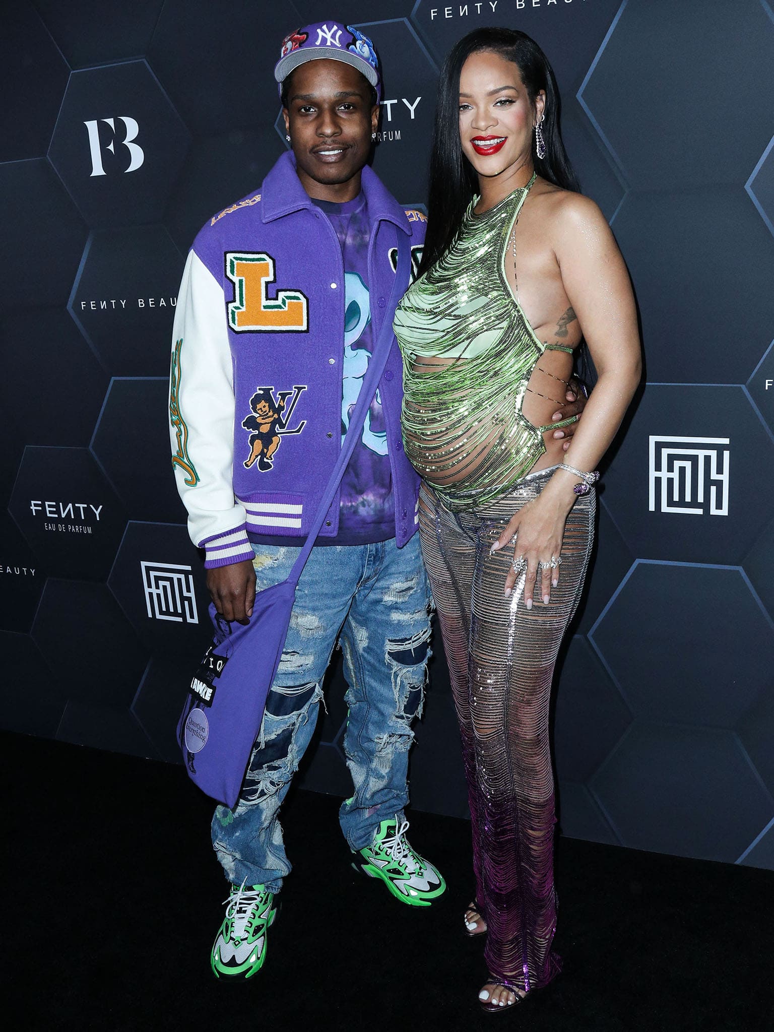 A$AP Rocky and pregnant Rihanna attend the Fenty Beauty and Fenty Skin photocall in Los Angeles on February 11, 2022, with Rihanna dazzling in a shredded green and purple sequin ensemble from The Attico and metallic purple Manolo Blahnik heels
