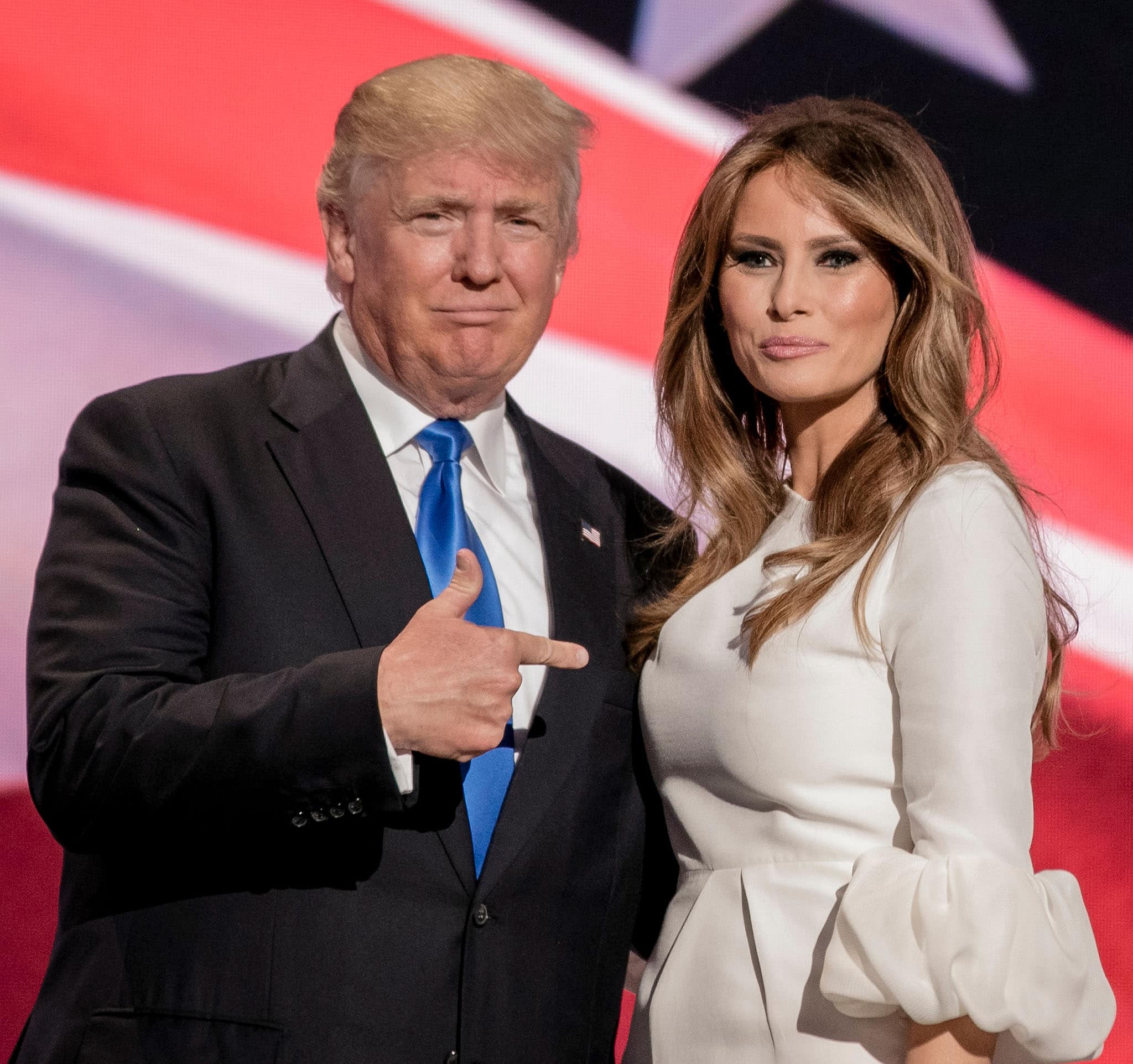 Melania Trump, standing at 5 feet 9 ¼ inches (175.9 cm), exudes classic elegance in a white puff-sleeve dress, her poised presence and statuesque frame perfectly complementing the formal setting alongside her husband