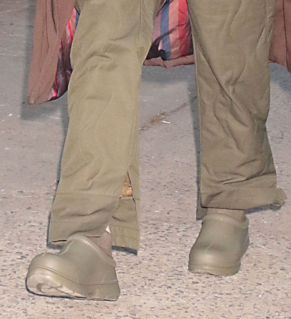 Close-up of Irina Shayk wearing olive UGG Tasman X waterproof clogs with wide-leg green pants