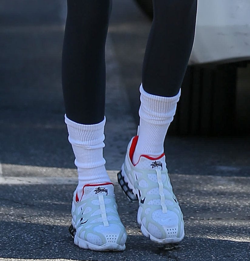 Kendall Jenner pairs her Pilates outfit with Stüssy x Nike Air Kukini Spiridon Cage 2 sneakers and white crew socks