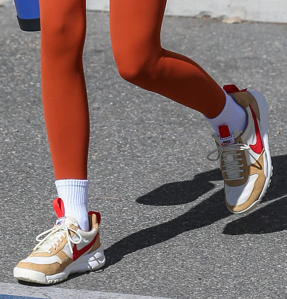 The Tom Sachs x NikeCraft Mars Yard 2.0 sneakers feature breathable mesh uppers, natural suede overlays, and signature red Swooshes