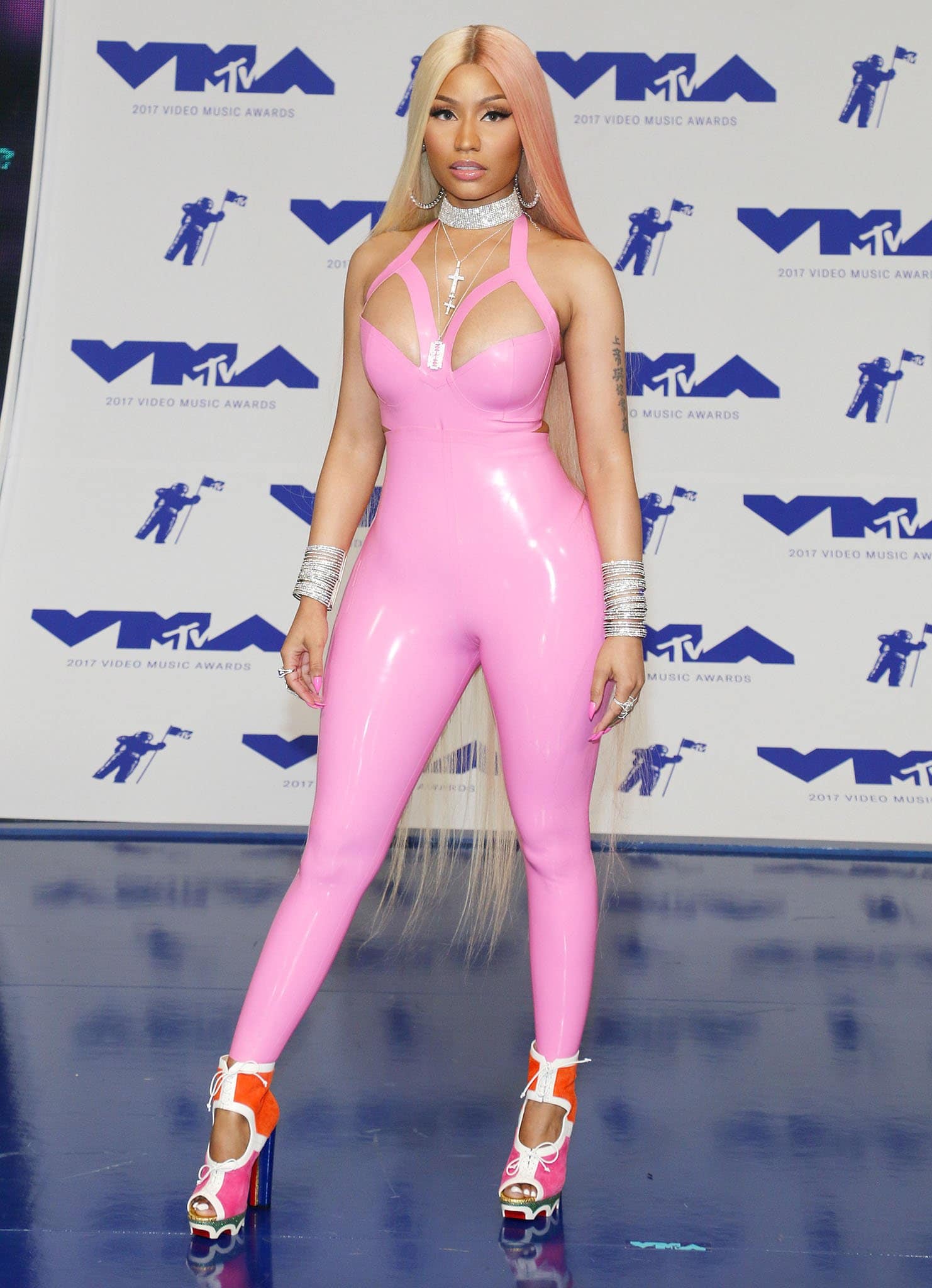 Nicki Minaj turned heads at the 2017 MTV VMAs in a skin-tight pink latex bodysuit paired with bold lace-up platform heels featuring vibrant orange, pink, and white accents