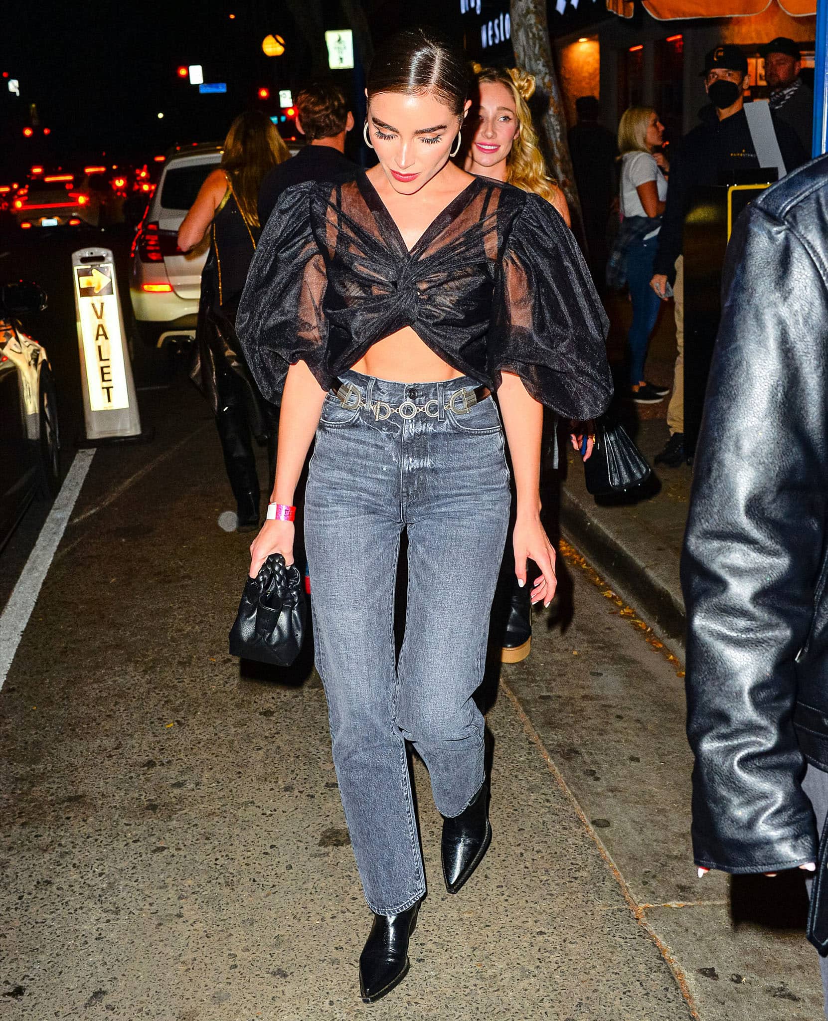 Olivia Culpo flashes her abs in Anouki see-through blouse and straight-leg jeans