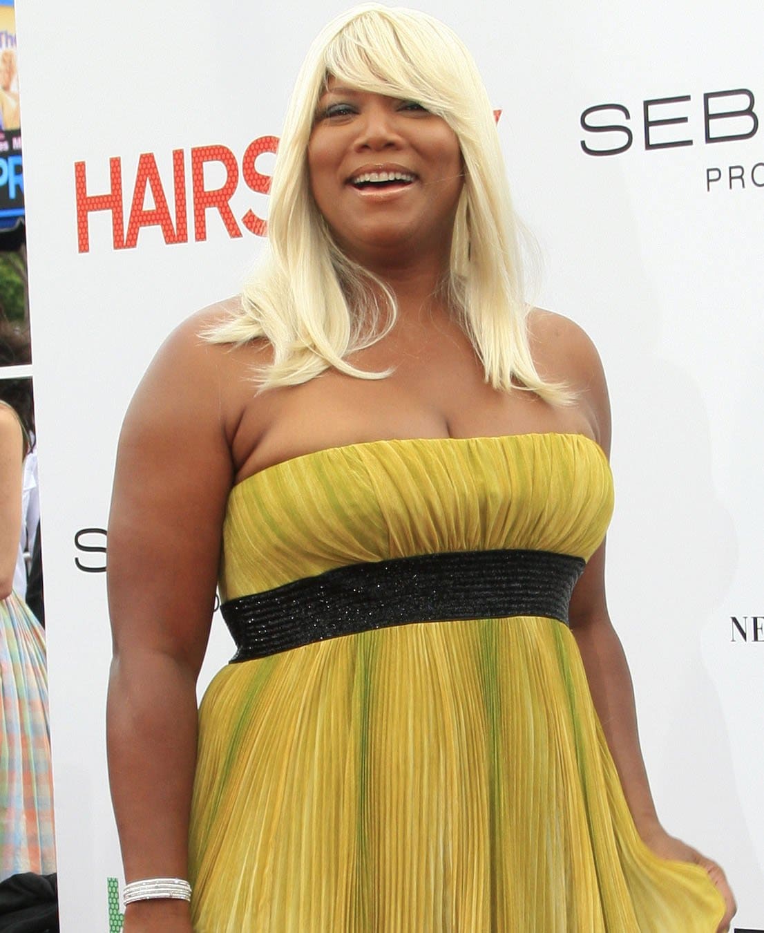 Queen Latifah glowed in a strapless pleated yellow gown with a black waistband, adding a pop of color and elegance at the Hairspray premiere