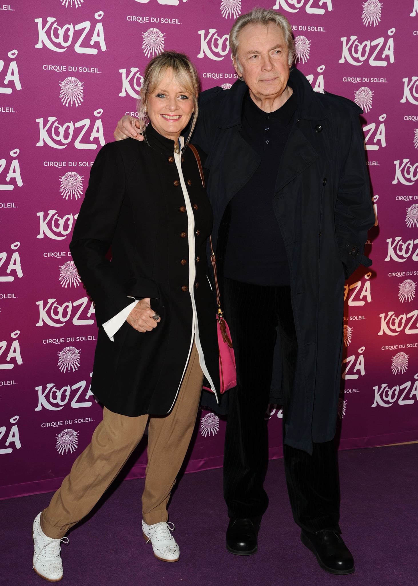 Twiggy, currently standing at 5 feet 5 inches (165.1 cm) with a peak height of 5 feet 6 inches (167.6 cm), brings effortless charm to the Cirque du Soleil Kooza event in a tailored black coat, tan trousers, and white brogues—perfectly blending classic style with playful flair