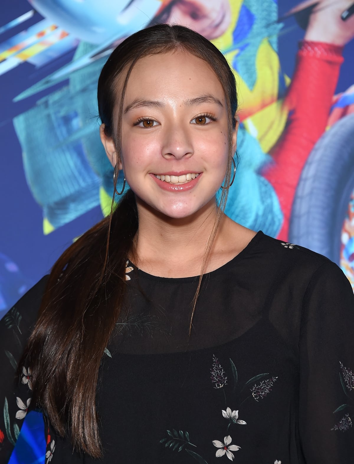 Aubrey Anderson-Emmons attended the premiere of Cirque Du Soleil's "Volta" at Dodger Stadium on January 21, 2020, in Los Angeles, glowing in a black floral-print blouse and hoop earrings that added a youthful yet polished touch to her look