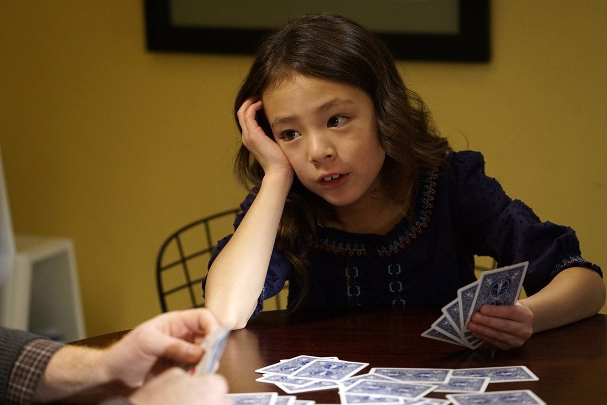 Aubrey Anderson-Emmons as Lily Tucker-Pritchett, looking unimpressed during a card game scene on ABC’s hit sitcom Modern Family, where she became a fan favorite for her witty lines and expressive reactions
