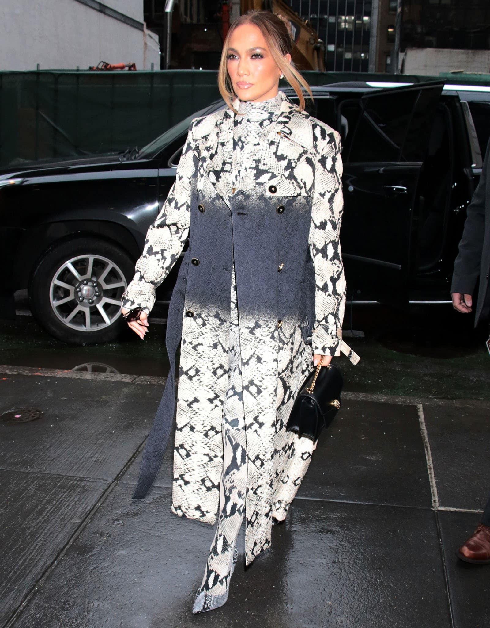 Jennifer Lopez exudes modern sophistication in a head-to-toe snakeskin Roberto Cavalli ensemble, complete with matching tights and sleek pointed-toe pumps