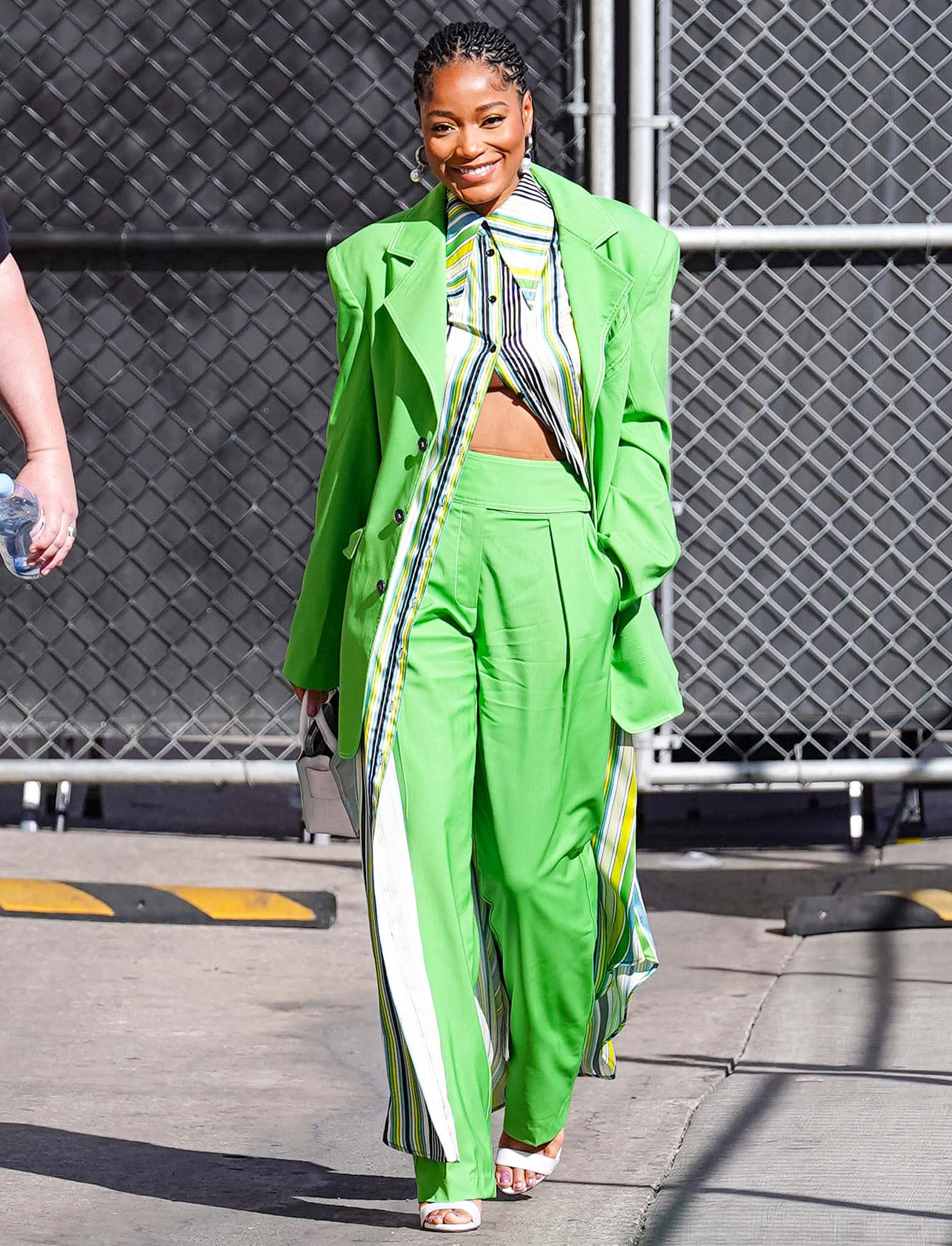 Keke Palmer elevates her lime-green Christopher John Rogers suit with crisp white Dolce Gabbana heels that add a sharp, modern finish to the look