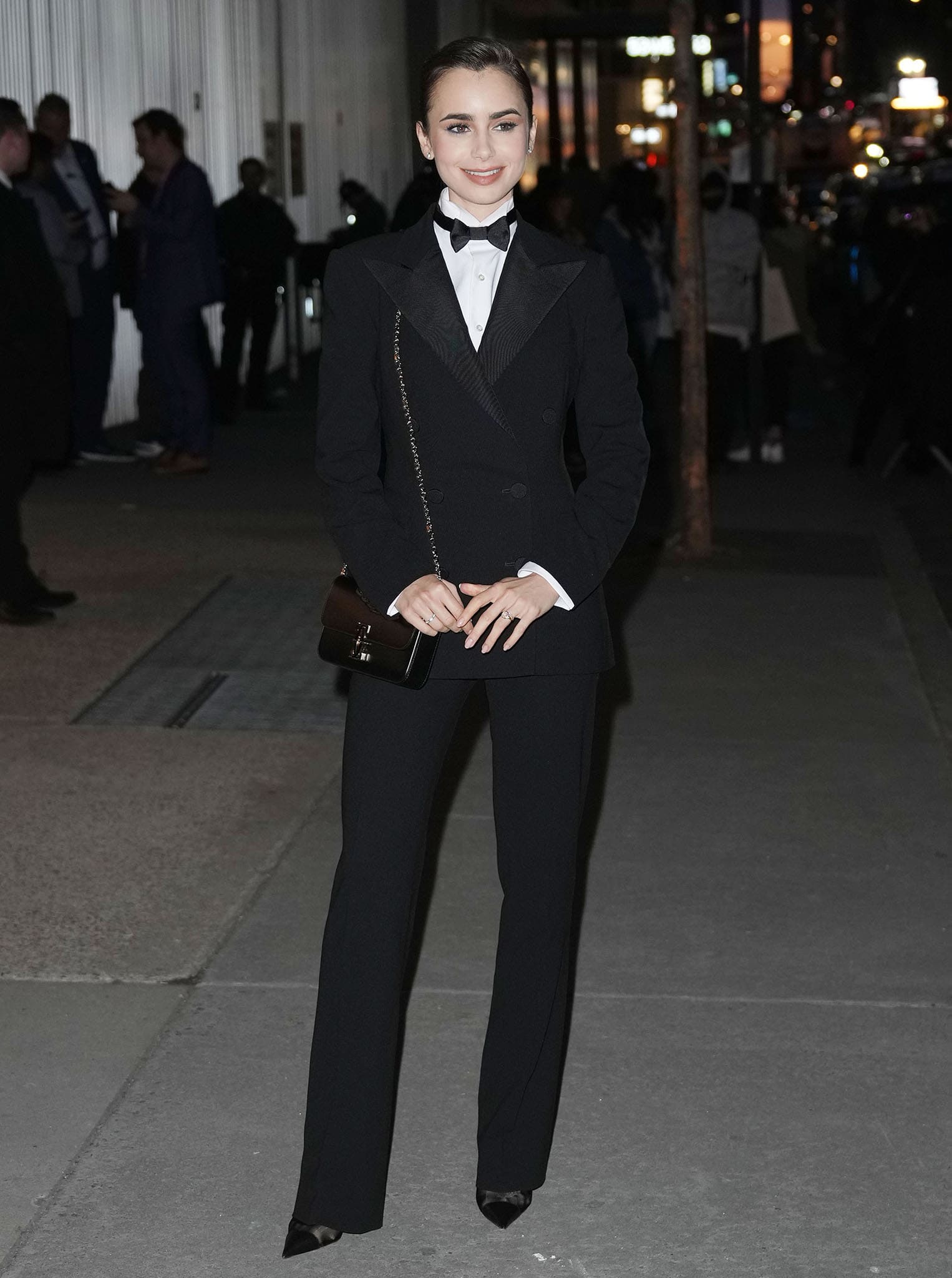 Lily Collins attends Ralph Lauren's Spring 2022 Ready to Wear runway presentation on March 22, 2022