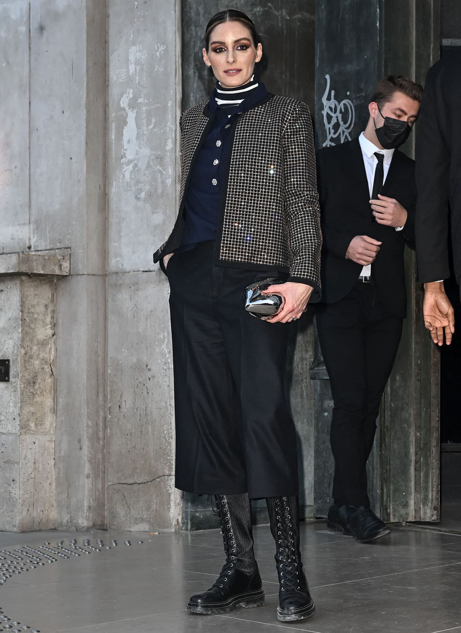 Olivia Palermo turns heads at Paris Fashion Week, pairing a crystal-embellished jacket with a striped turtleneck, culottes, and bold Gianvito Rossi combat boots during Elie Saab's runway presentation on March 5, 2022