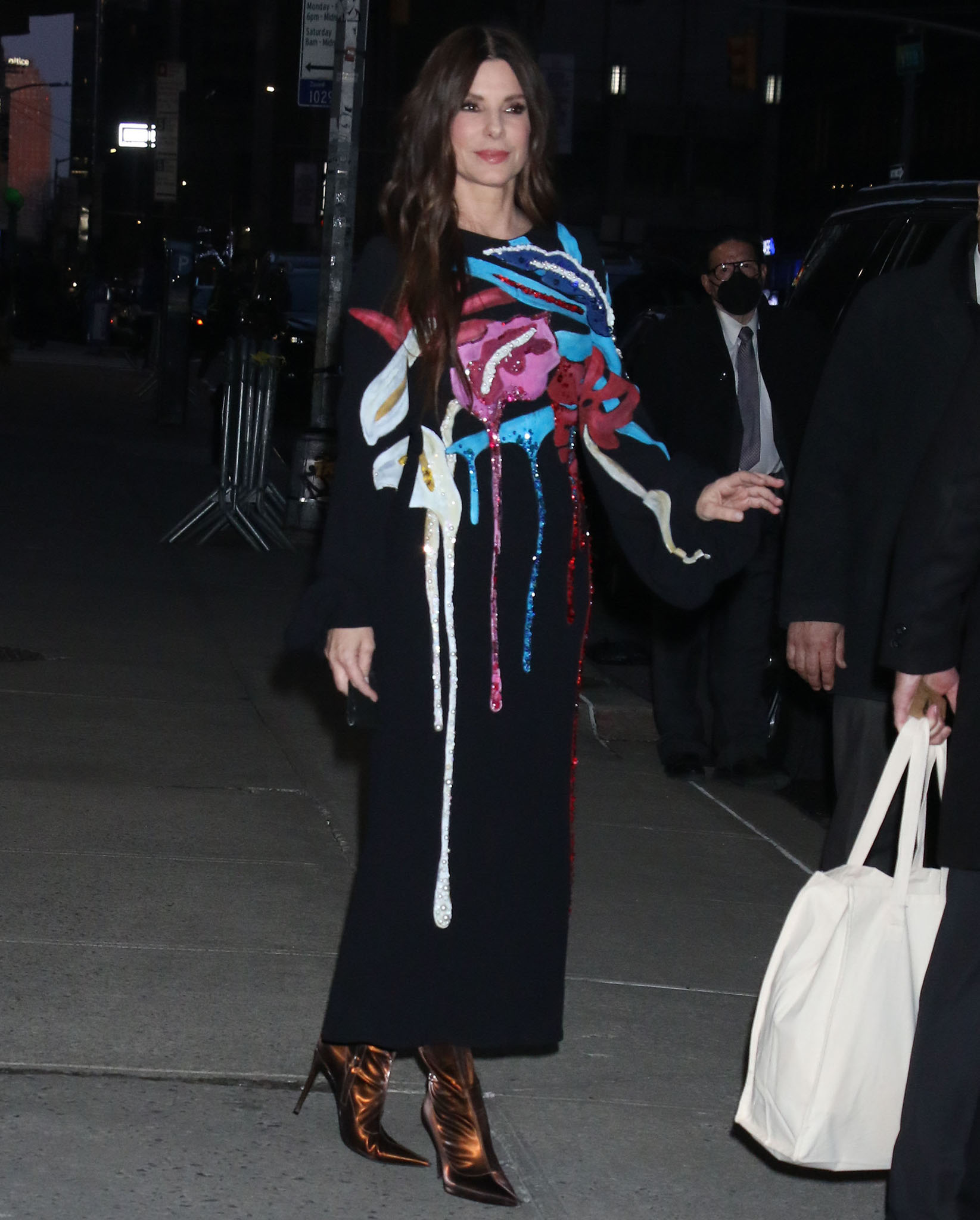 Sandra Bullock showcases bold style in a Stella Jean black midi dress with dripping sequin appliqués and metallic bronze Giuseppe Zanotti boots at The Lost City New York premiere on March 14, 2022