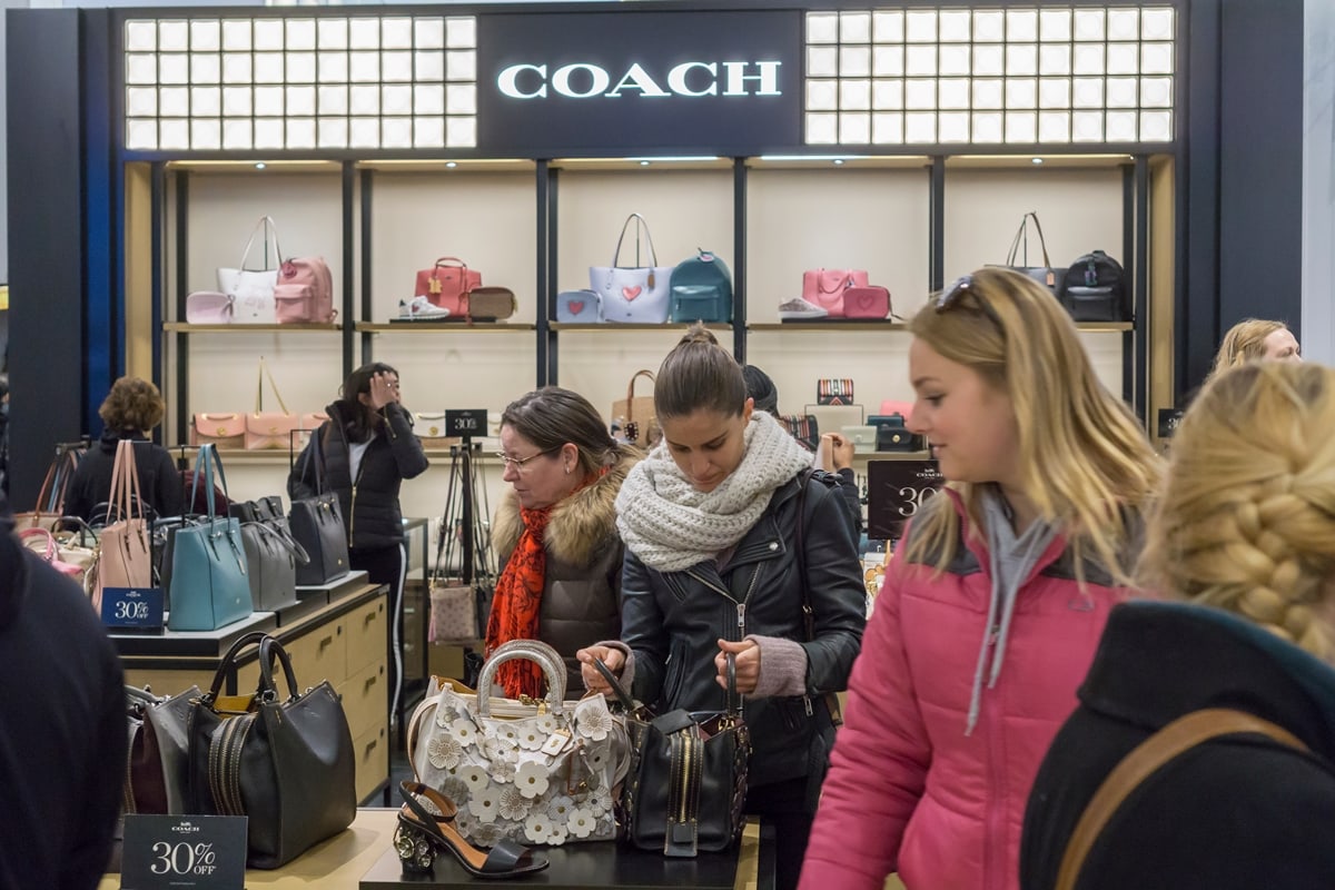 Coach shoppers browse handbags and accessories at Macy’s Herald Square in New York City, where the brand remains a favorite for accessible luxury