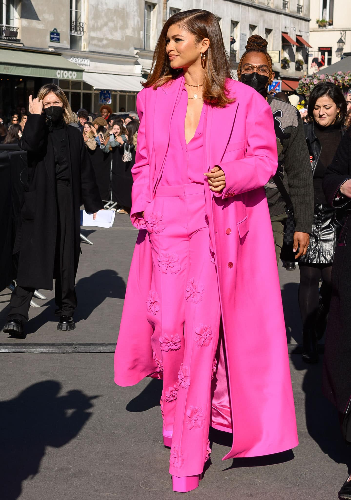 Zendaya commands attention in a head-to-toe Valentino “Pink PP” ensemble, pairing floral-appliqué trousers with towering platform pumps at the brand’s Fall/Winter 2022 show during Paris Fashion Week on March 6, 2022