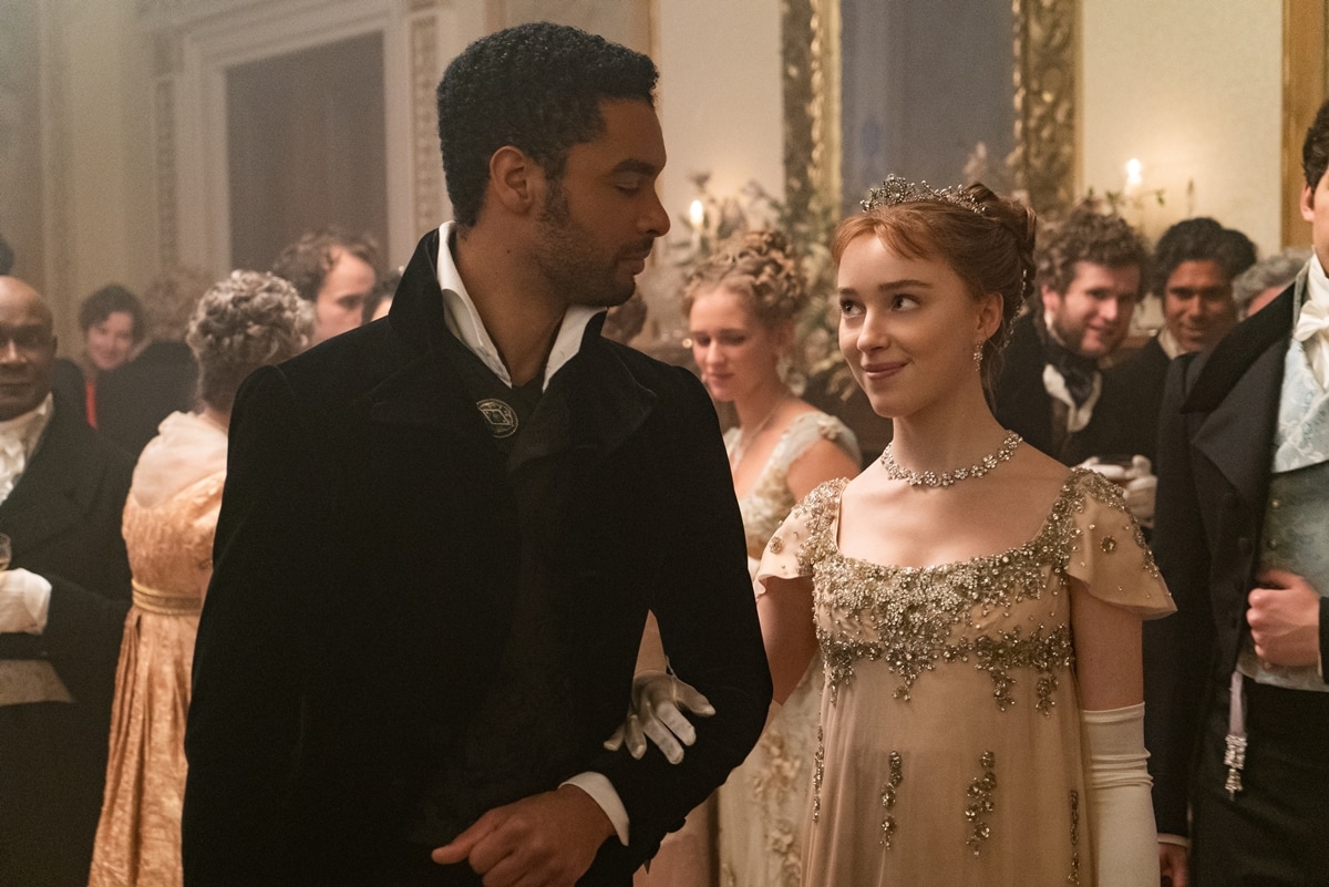 Phoebe Dynevor stuns as Daphne Basset in an embellished empire-waist gown alongside Regé-Jean Page as Simon Basset in the lavishly styled period drama Bridgerton