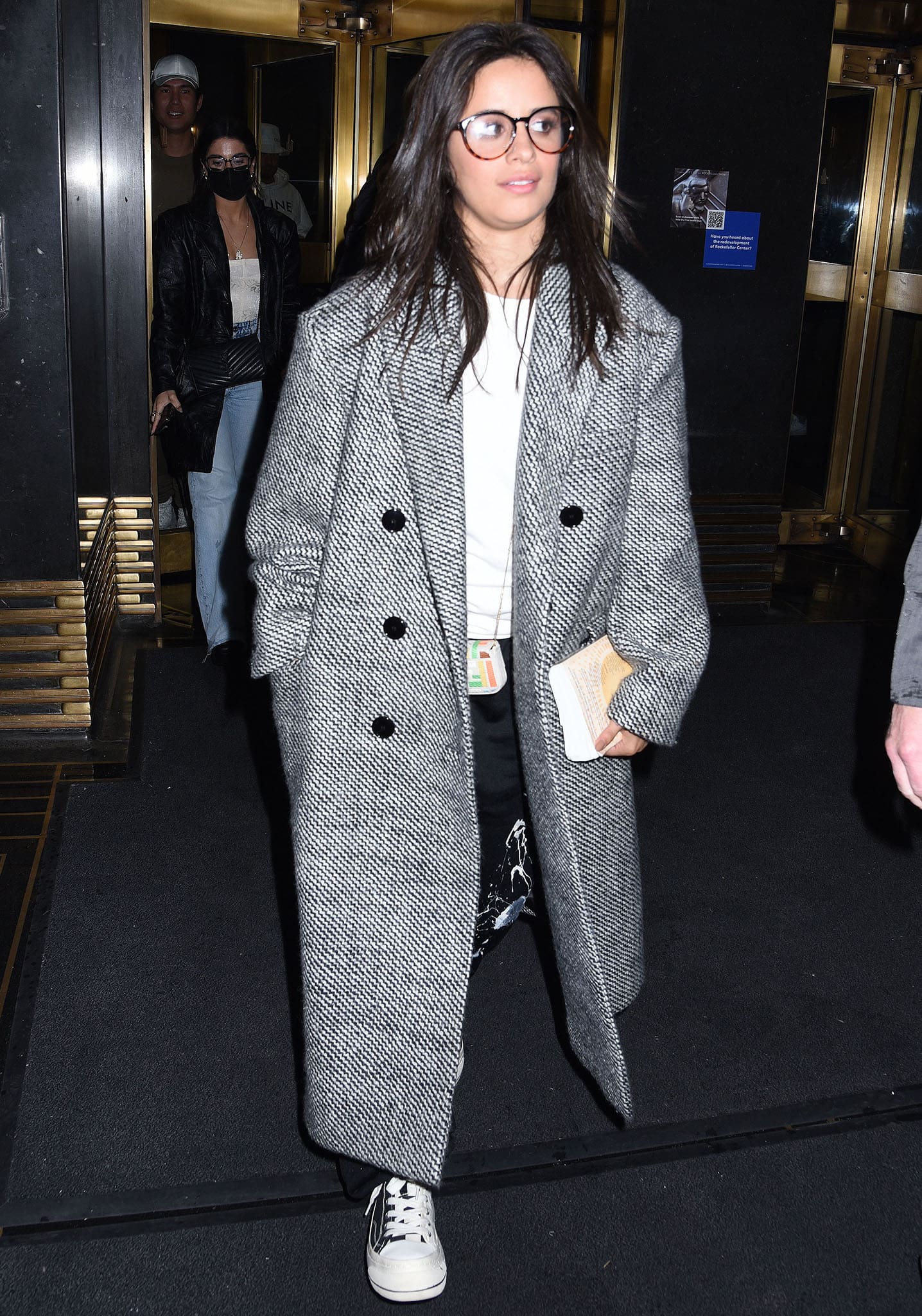 Camila Cabello stepped out en route to The Tonight Show Starring Jimmy Fallon, grounding her Balenciaga paint-splatter track pants and oversized tweed coat with classic black-and-white Converse sneakers for an effortlessly cool, off-duty finish
