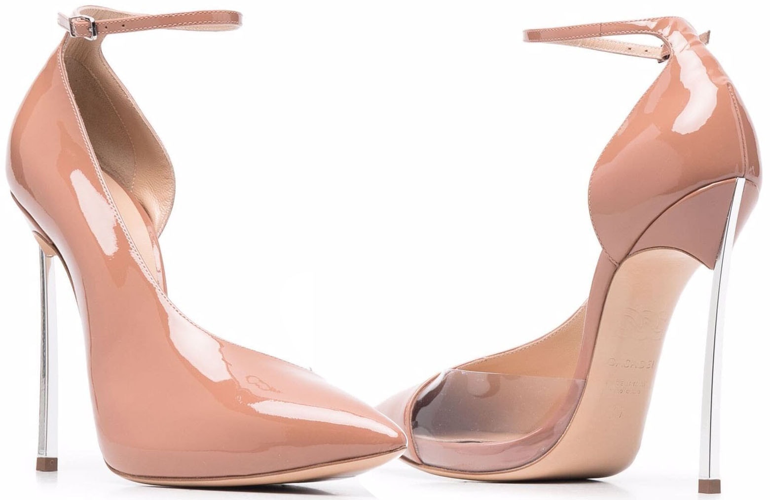 Casadei's "Roxanne" pumps pair glossy sandstone patent leather with transparent PVC side panels and the Italian label's signature stainless steel Blade heels, creating a sleek barely-there silhouette that elongates the leg