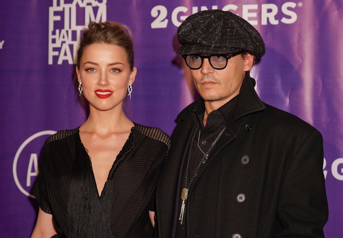 Amber Heard, in a sleek black dress with statement earrings, poses alongside Johnny Depp in a dark coat and newsboy cap at the Texas Film Hall of Fame Awards