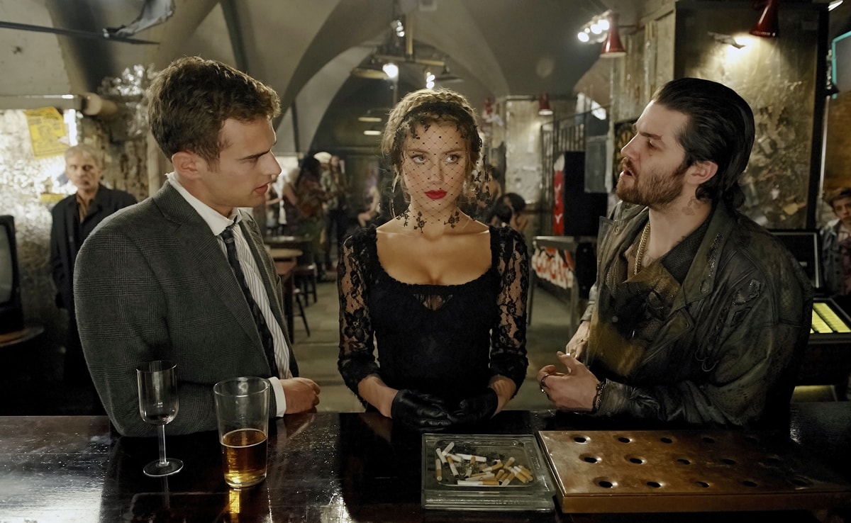 Amber Heard as Nicola Six wears a black lace dress with gloves and a veiled headpiece, alongside Theo James as Guy Clinch and Jim Sturgess as Keith Talent in the 2018 mystery thriller London Fields