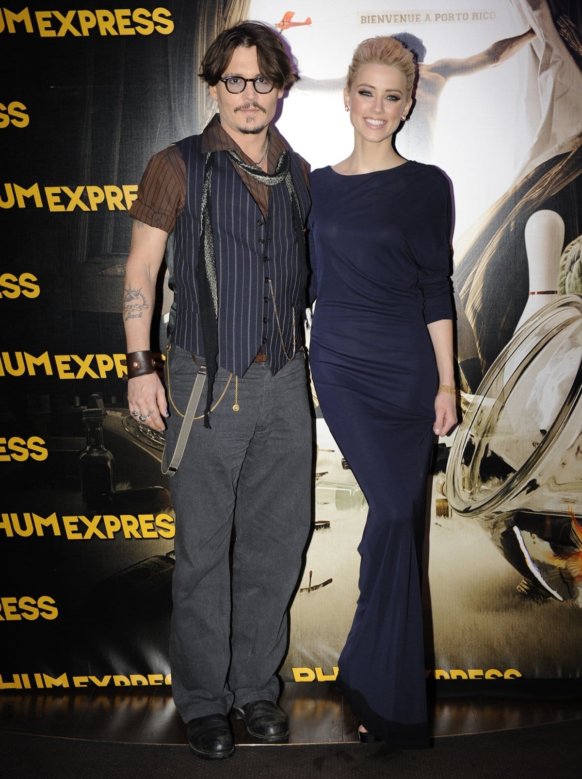 Johnny Depp and Amber Heard attend the Paris premiere of The Rum Diary on November 8, 2011, with Heard in a navy Stella McCartney gown styled with Boucheron jewelry and classic black platform pumps