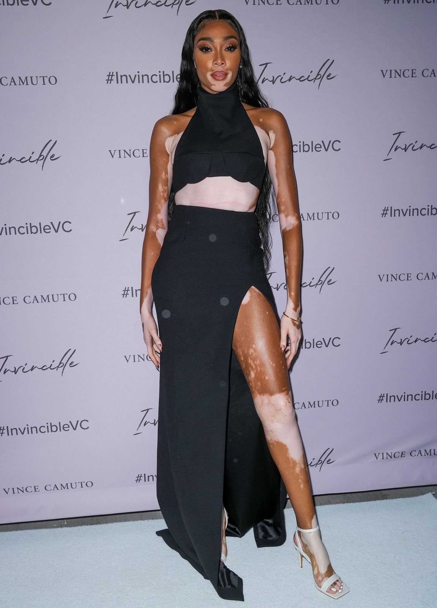 Winnie Harlow offsets her dramatic LaQuan Smith ensemble with crisp white Vince Camuto Saprenda2 sandals that immediately draw the eye