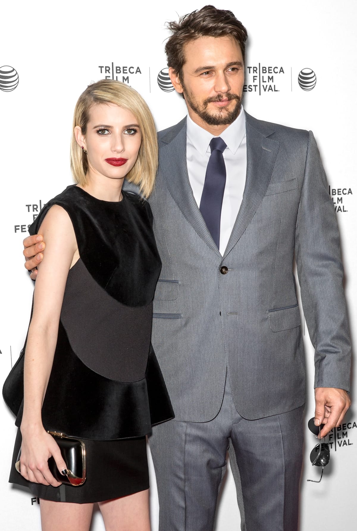 Emma Roberts pairs a sculptural black Saint Laurent mini with sleek heels while James Franco keeps it classic in a tailored gray suit at the Palo Alto premiere in Los Angeles