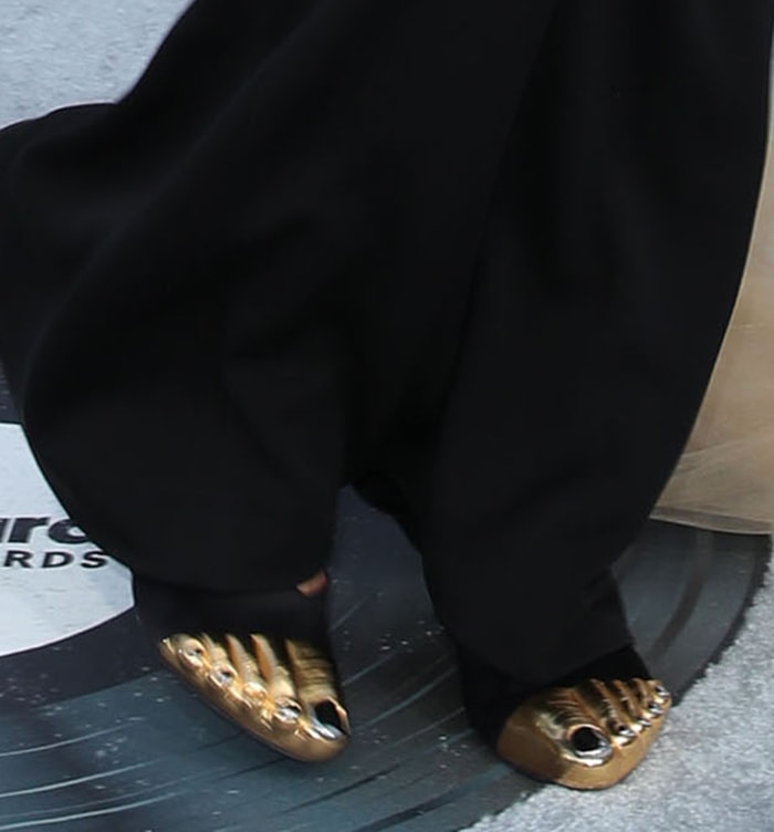 Doja Cat's Schiaparelli satin mules feature sculpted metallic toes with silver nail detailing, one of Daniel Roseberry’s most recognizable footwear designs