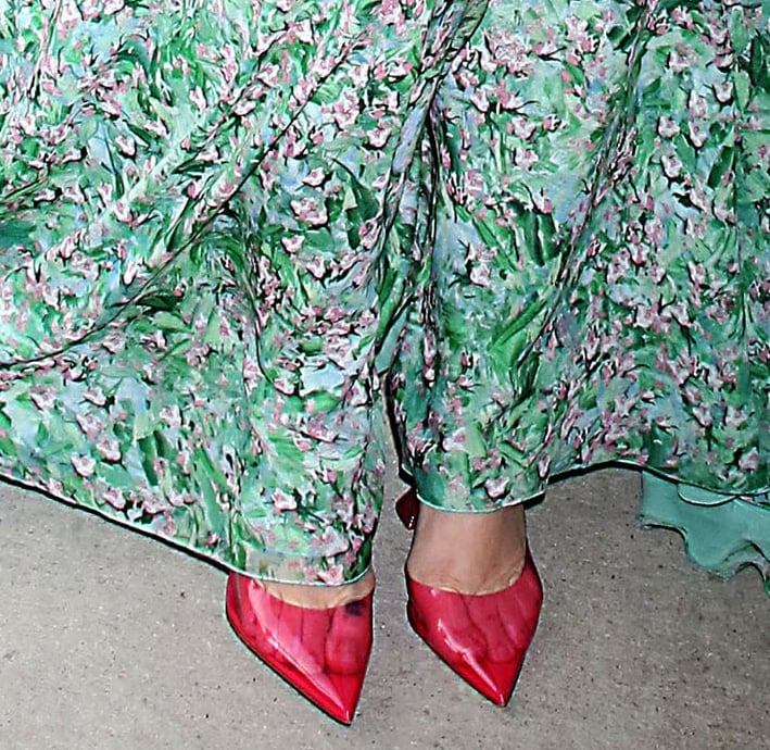 Drew Barrymore pairs her green floral maxi dress with red Amina Muaddi PVC pumps