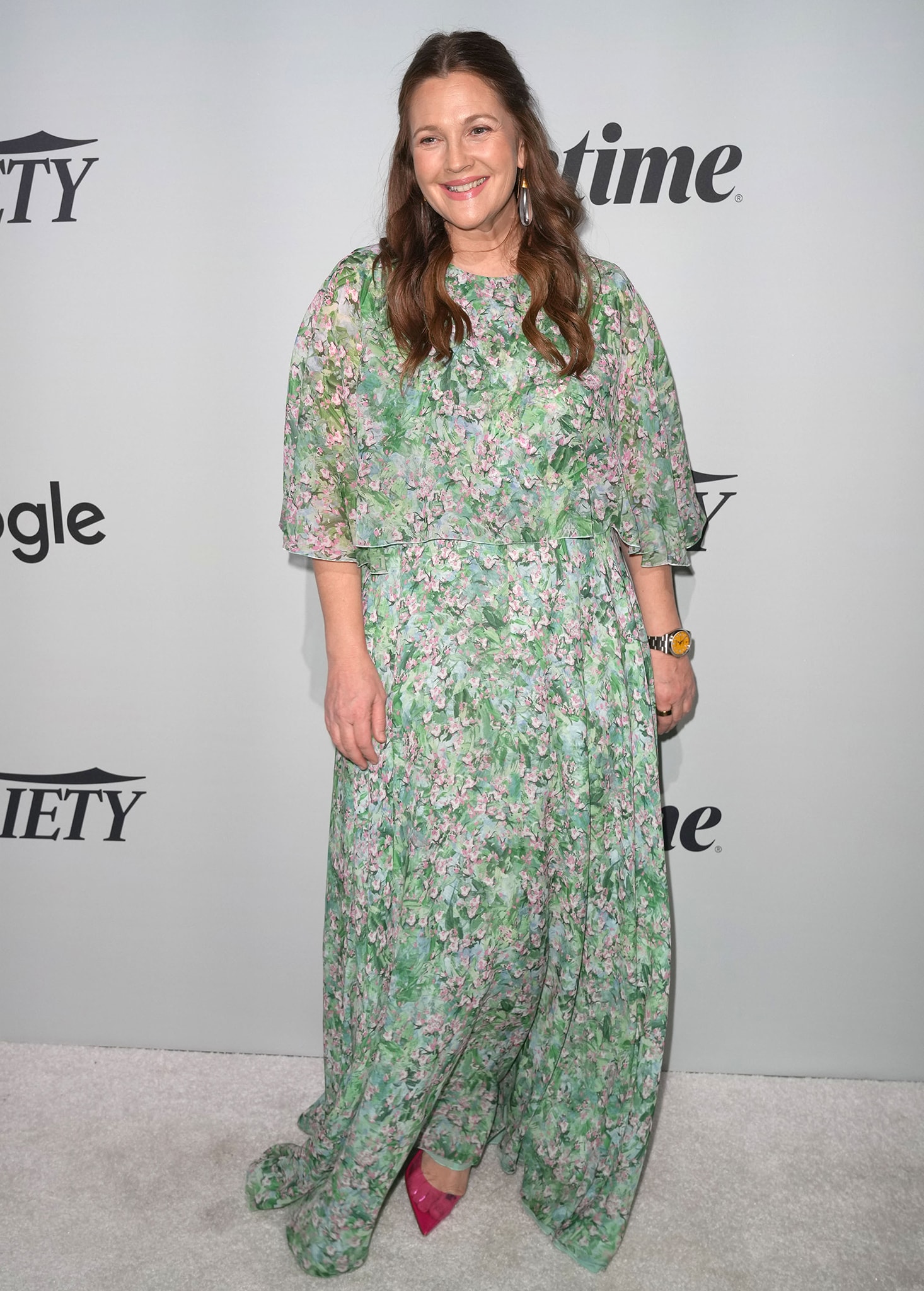 On the red carpet, Drew keeps the look effortless yet elegant in her floral Giambattista Valli gown, complemented by soft waves and delicate pink makeup