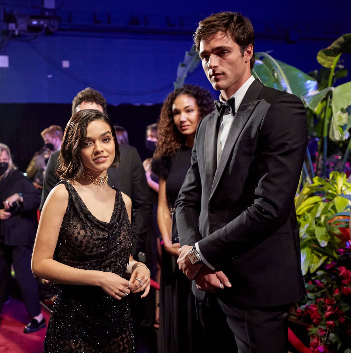 Jacob Elordi (6ft 5/195.6 cm, US shoe size 13) towers over his petite co-presenter Rachel Zegler (5ft 2/157.5 cm) backstage at the 94th Academy Awards, where she stunned in a sheer black Dior Haute Couture gown with Tiffany Co. jewels