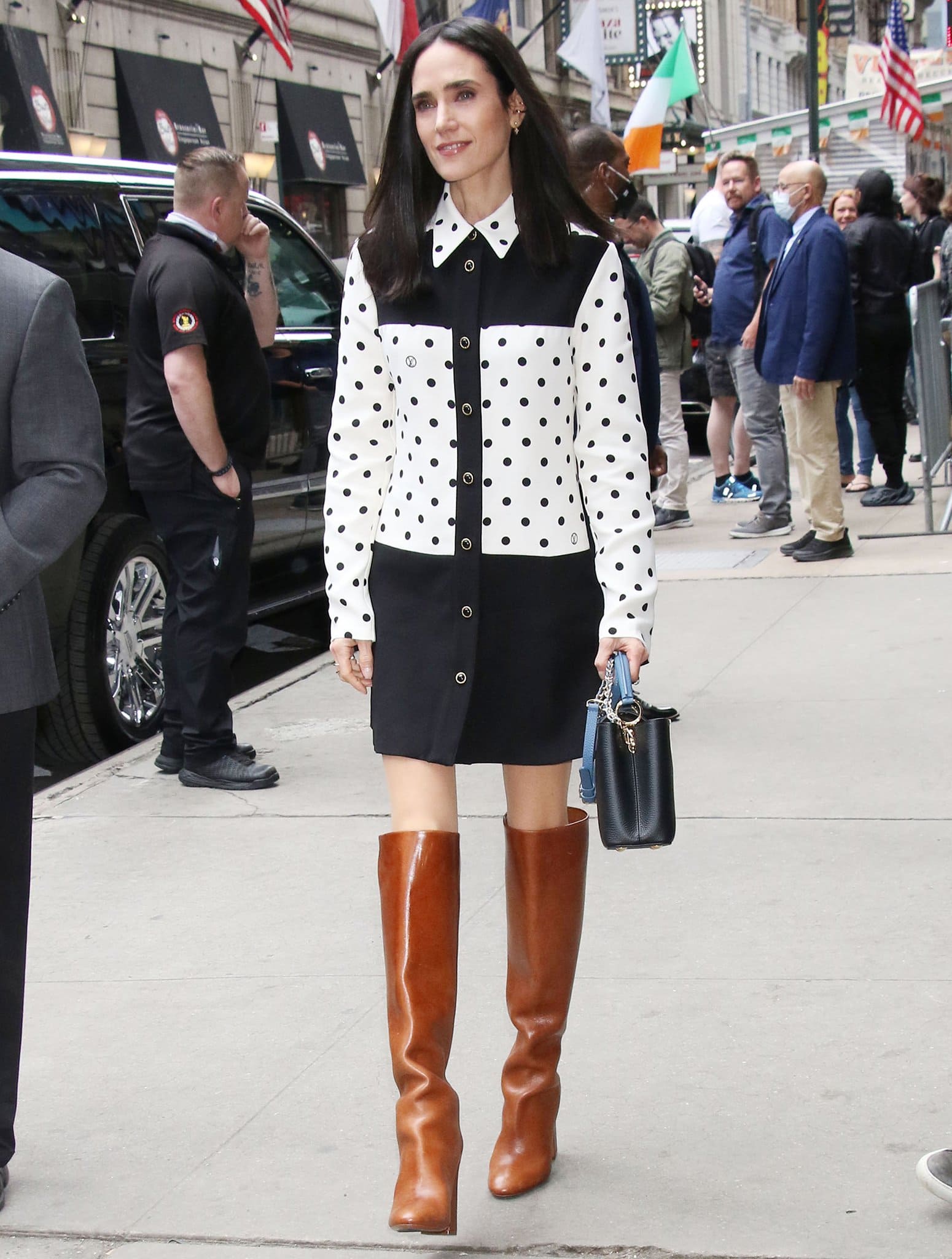 Jennifer Connelly arrives at the Good Morning America studios in New York City on May 24, 2022, wearing a Louis Vuitton polka-dot shirtdress styled with cognac knee-high leather boots and a black top-handle bag