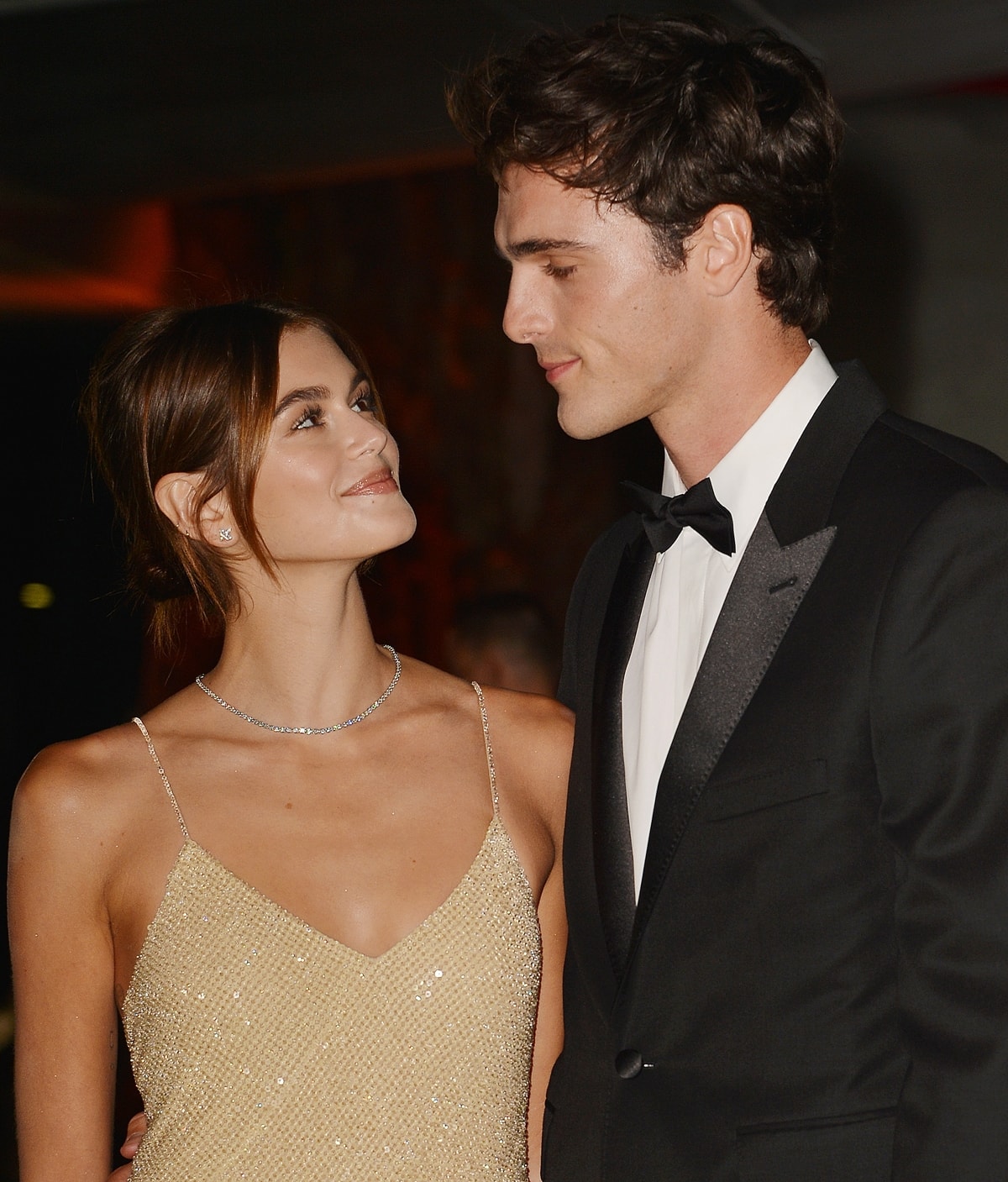 Kaia Gerber, radiant in a sparkling champagne slip dress, shares a red-carpet moment with then-boyfriend Jacob Elordi, who dated the model for about a year before their split in late 2021