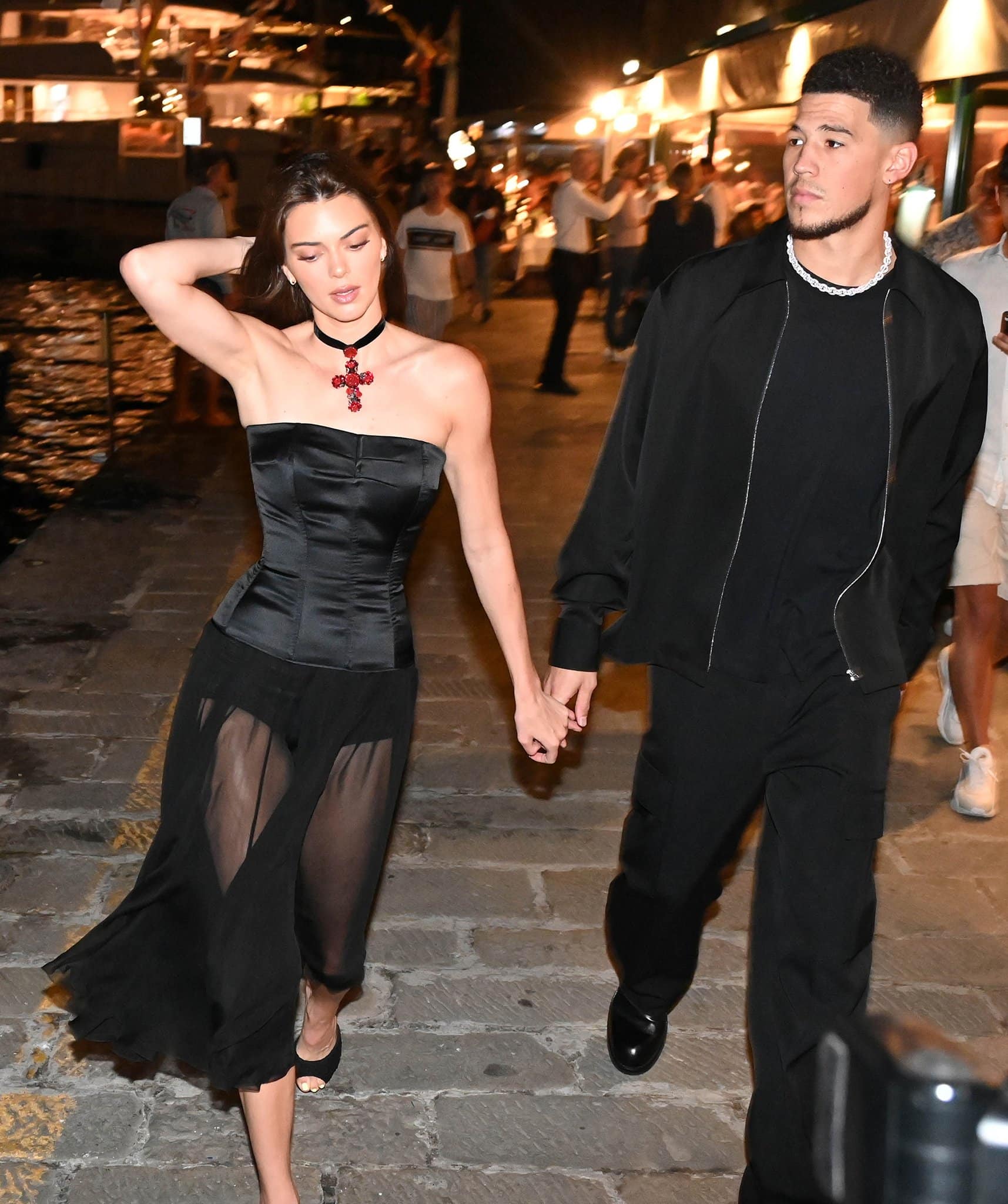 Kendall Jenner displays her model legs in DG 1995 sheer black dress with Devin Booker in coordinating black ensemble