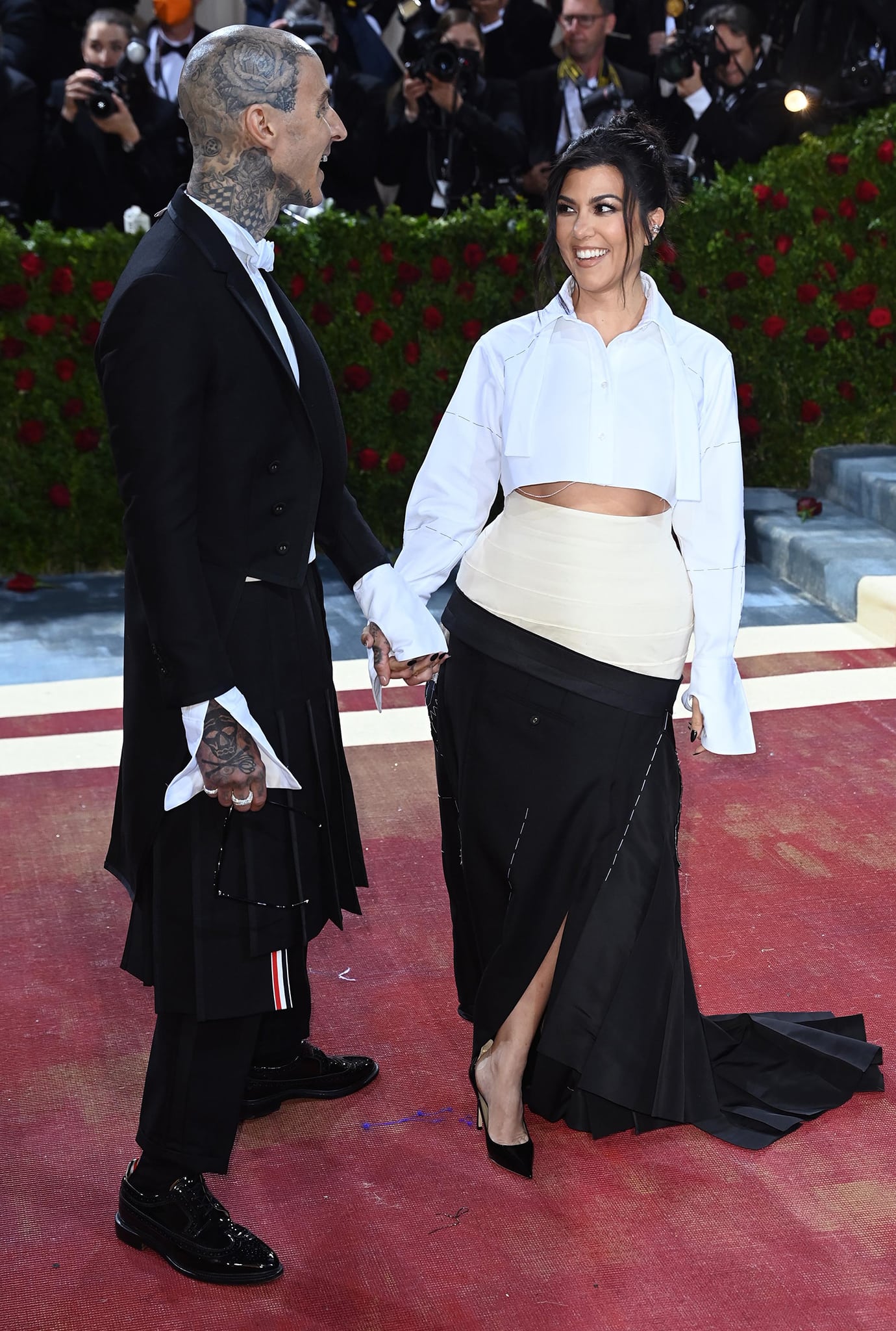 Travis Barker finishes his Met Gala look with glossy black patent dress shoes, while Kourtney Kardashian adds height and polish in sleek pointed-toe Jimmy Choo pumps