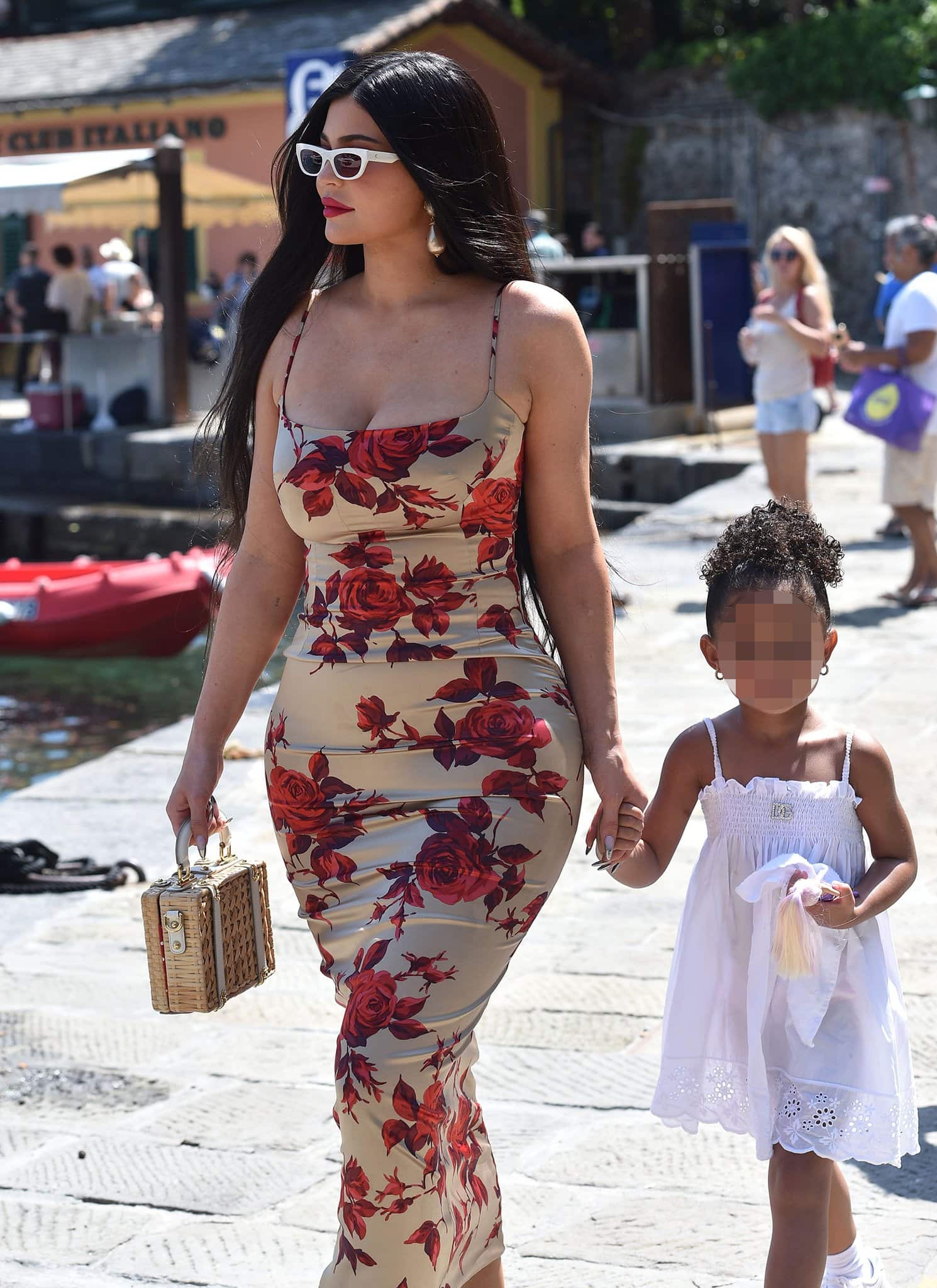 Kylie Jenner glams up with red lipstick, white sunnies, and chunky drop earrings