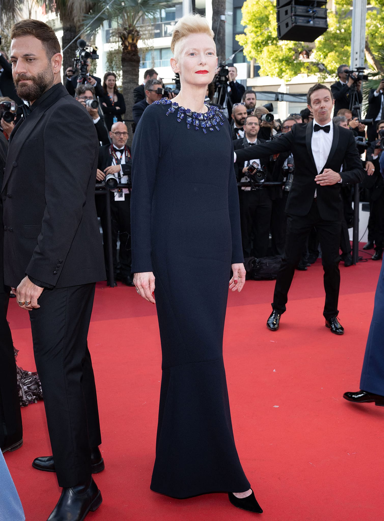 Tilda Swinton’s streamlined navy Chanel gown falls into a fluted hem that reveals her black suede pointed-toe pumps at the Three Thousand Years of Longing premiere during the 75th Cannes Film Festival