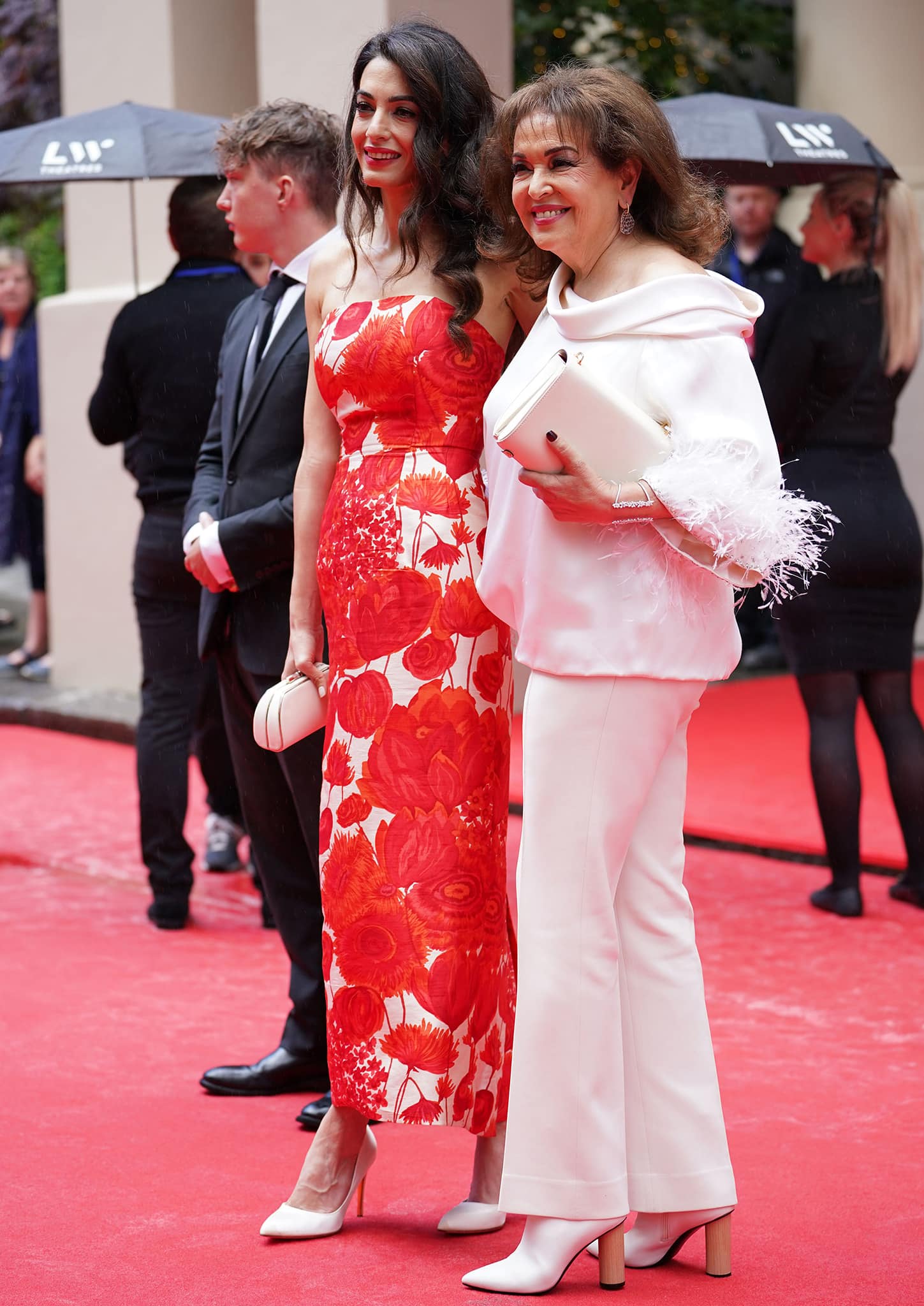 Amal Clooney brings her mom, Baria Alamuddin, who looks chic in an all-white ensemble