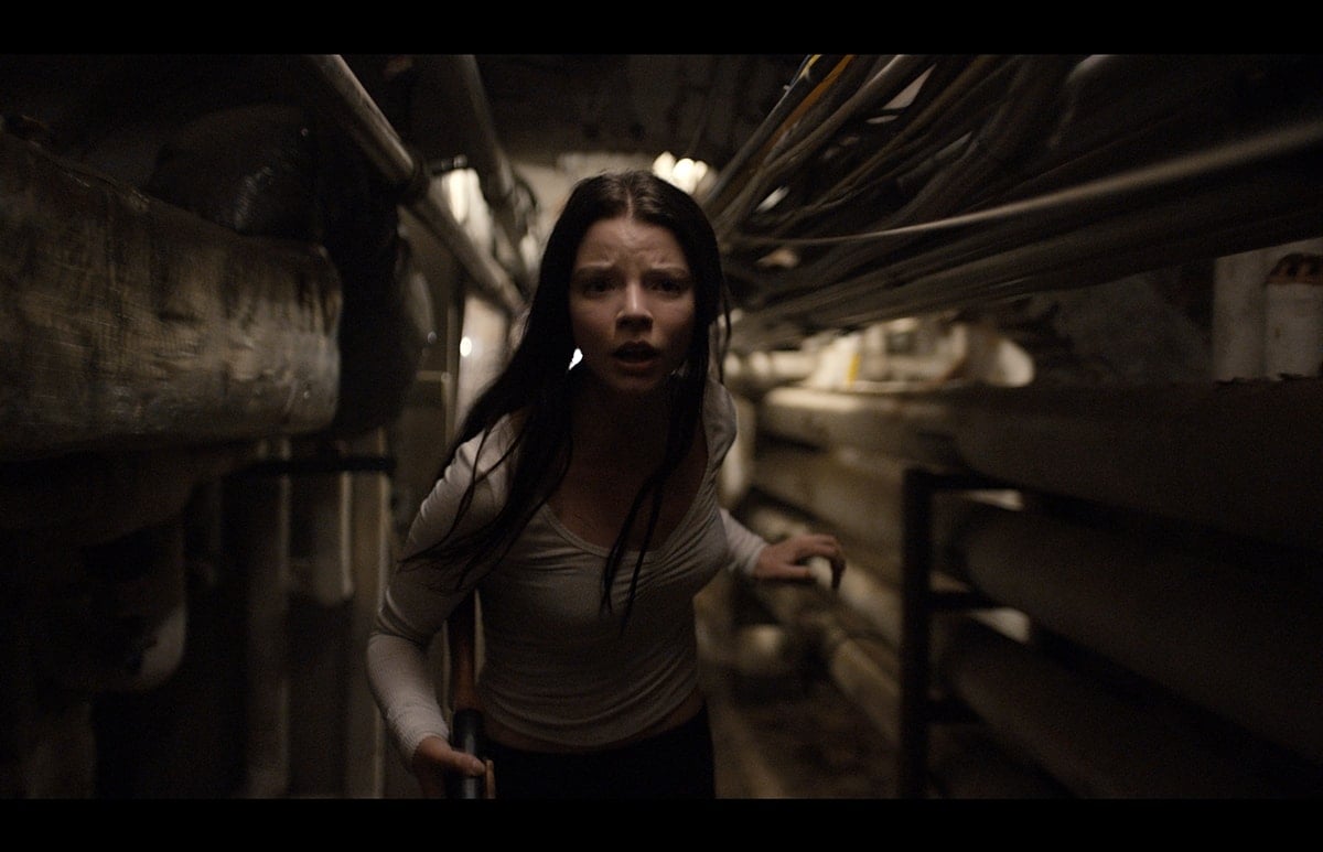 Anya Taylor-Joy delivers raw intensity as Casey Cooke in Split, wearing a distressed ivory long-sleeve top that mirrors her character’s vulnerability and resilience in the film’s tense underground setting