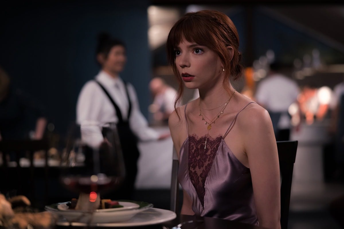 Anya Taylor-Joy serves up quiet intensity and sleek style in The Menu, wearing a satin lavender slip dress with lace detailing—her look equal parts sultry and suspenseful amid the film’s chilling fine-dining setting