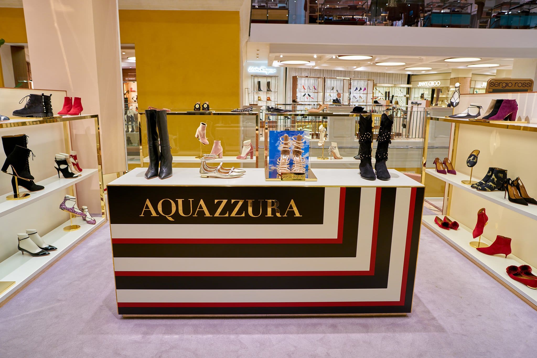 Aquazzura’s luxury footwear display showcases the brand’s commitment to Italian craftsmanship, featuring bold, fashion-forward designs handcrafted in Florence from premium leather