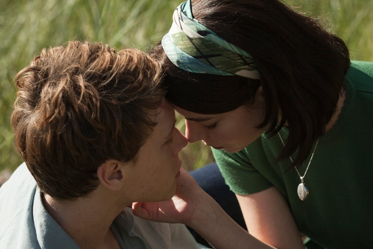 IIn a tender moment from Marrowbone, Anya Taylor-Joy wears a soft green knit top, a leaf-print headscarf, and a vintage silver locket—capturing her character Allie’s quiet warmth and timeless, countryside charm