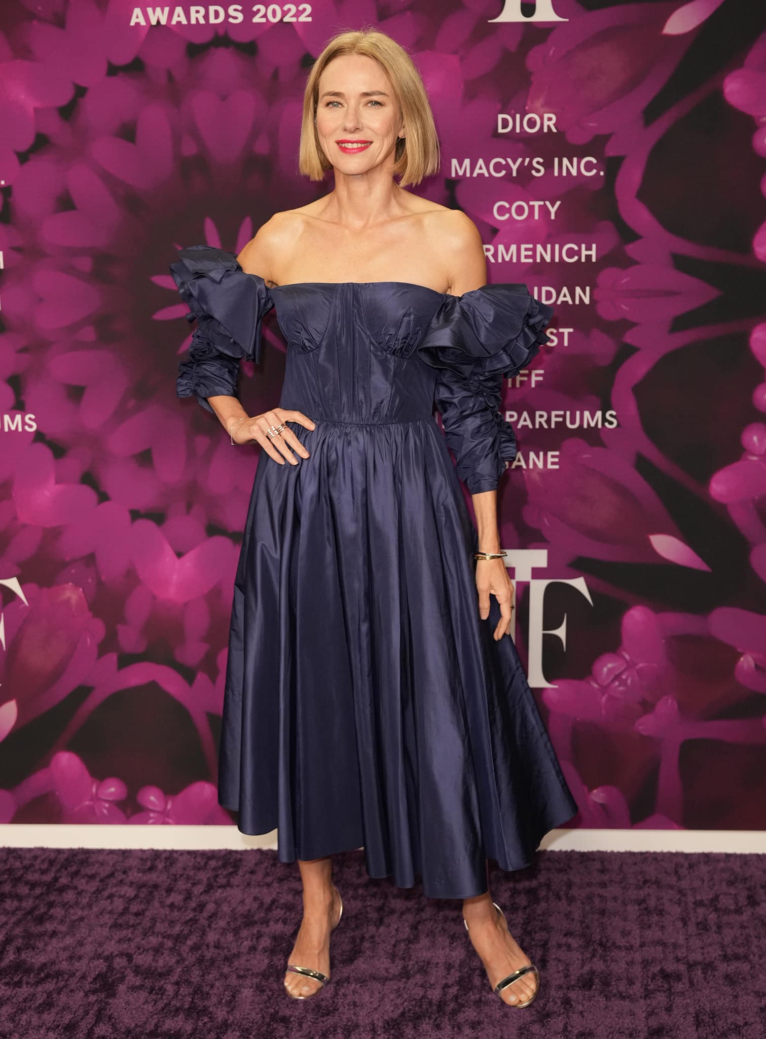 Naomi Watts presents a head-to-toe view of her Fragrance Foundation Awards ensemble, balancing voluminous navy couture with minimalist silver Aquazzura heels.